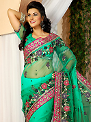 Elegance and innovation of designs crafted for you. This green net saree is nicely designed with embroidered patch work is done with resham, zari and stone work. Beautiful embroidery work on saree make attractive to impress all. This saree gives you a modern and different look in fabulous style. Matching blouse is available. Slight color variations are possible due to differing screen and photograph resolution.