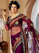 The traditional patterns used on this saree maintain the ethnic look. This burgundy net saree is nicely designed with embroidery and velvet patch work is done with resham, zari and stone work. Beautiful embroidery work on saree make attractive to impress all. This saree gives you a modern and different look in fabulous style. Matching blouse is available. Slight color variations are possible due to differing screen and photograph resolution.