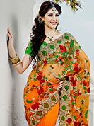 Envelope yourself in classic look with this charming saree. This shaded orange net saree have beautiful embroidery patch work which is embellished with resham and stone work. Fabulous designed embroidery gives you an ethnic look and increasing your beauty. Contrasting green blouse is available. Slight Color variations are possible due to differing screen and photograph resolutions.
