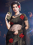 The fascinating beautiful subtly garment with lovely patterns. This black net saree have beautiful embroidery patch work which is embellished with resham, stone and beads work. Fabulous designed embroidery gives you an ethnic look and increasing your beauty. Matching blouse is available. Slight Color variations are possible due to differing screen and photograph resolutions.