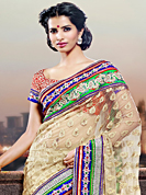The most beautiful refinements for style and tradition. This cream net saree have beautiful embroidery patch work which is embellished with resham, zari and stone work. Fabulous designed embroidery gives you an ethnic look and increasing your beauty. Contrasting red blouse is available. Slight Color variations are possible due to differing screen and photograph resolutions.
