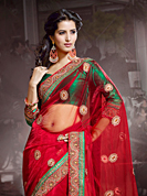 Exquisite combination of color, fabric can be seen here. This red net saree have beautiful embroidery patch work which is embellished with zari, sequins and stone work. Fabulous designed embroidery gives you an ethnic look and increasing your beauty. Contrasting green blouse is available. Slight Color variations are possible due to differing screen and photograph resolutions.