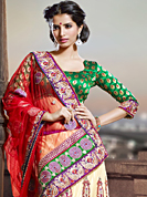The traditional patterns used on this saree maintain the ethnic look. This red and cream net lehenga style saree have beautiful embroidery patch work which is embellished with resham, zari and stone work. Fabulous designed embroidery gives you an ethnic look and increasing your beauty. Contrasting green blouse is available. Slight Color variations are possible due to differing screen and photograph resolutions.