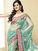 Symbol of fashion and beauty, each piece of our range of Net saree is certain to increase your look. Lehanga style Aqua green net saree have beautiful rich embroidered border. Bright red floral Border is embellished with resham, stones, and zari work. Embroidered floral butti on all over saree. This saree gives you a singular look. Slight Color variations possible due to differing screen and photograph resolutions.