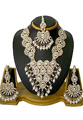 Breathtaking necklace set designed in a very unique approach. A drop shape pattern on whole necklace studded with diamonds with hanging white moti in parallel. A pair of matching earrings and maangtika include with this necklace. Keep away from water, sweat and perfume. Slight Color variations are possible due to differing screen and photograph resolution.