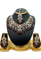 Classic and elegant necklace creations offered are a mix of traditional and ultramodern designs. A beautiful necklace designed in drops pattern studded with diamonds, maroon beads and hanging crystal moti. A pair of matching earrings and maangtika embraces with this necklace. Keep away from water, sweat and perfume. Slight Color variations are possible due to differing screen and photograph resolution.