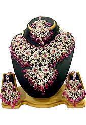 Breathtaking necklace set designed in a very unique approach. This beautiful pink wedding and bridal purpose necklace awesomely crafted with white and pink diamonds studded drop frame with hanging crystal moti. A pair of matching earrings and beautiful maangtika embraces with this necklace. Keep away from water, sweat and perfume. Slight Color variations are possible due to differing screen and photograph resolution.