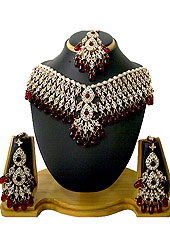 The necklace set looks excellent with delicate & elegant work. Diamonds studded drops frames with maroon stone and hanging crystal moti work used in this necklace. It’s a wedding purpose set. A pair of matching earrings and beautiful maangtika embraces with this necklace. Keep away from water, sweat and perfume. Slight Color variations are possible due to differing screen and photograph resolution.
