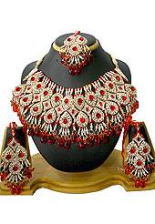Classic and elegant necklace creations offered are a mix of traditional and ultramodern designs. A beautiful necklace designed in drops pattern studded with diamonds, red beads and hanging crystal moti. A pair of matching earrings and maangtika embraces with this necklace. Keep away from water, sweat and perfume. Slight Color variations are possible due to differing screen and photograph resolution.