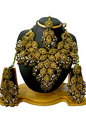 Traditional and ethnic necklace is perfect for occasion like weddings. This beautiful green wedding and bridal purpose necklace awesomely crafted in eye shaped frames studded with brown and green diamonds with hanging beads and white diamonds. A pair of matching earrings and beautiful maangtika embraces with this necklace. Keep away from water, sweat and perfume. Slight Color variations are possible due to differing screen and photograph resolution.