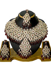 Each design has been carefully crafted keeping in mind the taste of today’s Indian woman. A eye shape pattern on whole necklace studded with white and maroon diamonds with hanging maroon crystal moti in parallel. A pair of matching earrings and maangtika include with this necklace. Keep away from water, sweat and perfume. Slight Color variations are possible due to differing screen and photograph resolution.