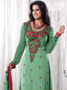 A desire that evokes a sense of belonging with a striking details. This pastel green and maroon A-Line kameez has beautiful embroidered patch work done with resham, sequins and dupion work in form of floral motifs. Embroidery on kameez and dupatta is highlighting the beauty of this suit. Color combination of this suit is captivating and makes an impression to all. Matching Churidar and dupatta come along with this suit. This beautiful party wear made with georgette fabric. Slight Color variations are possible due to differing screen and photograph resolutions.