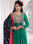 The popularity of this dress comes from the fact that it showcases the beauty modesty as well as exquisitely. This green and black anarkali kameez has beautiful embroidered patch work done with resham, sequins, zari and dupion work in form of floral motifs. Embroidery on kameez and dupatta is highlighting the beauty of this suit. Color combination of this suit is captivating and makes an impression to all. Santoon churidar and chiffon dupatta come along with this suit. This beautiful party wear made with georgette fabric. Slight Color variations are possible due to differing screen and photograph resolutions.