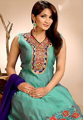 A desire that evokes a sense of belonging with a striking details. The dazzling teal green dupion silk readymade churidar suit have amazing embroidery patch work is done with resham and zari work. The entire ensemble makes an excellent wear. Contrasting dark blue churidar and dupatta is available with this suit. Slight Color variations are possible due to differing screen and photograph resolutions.