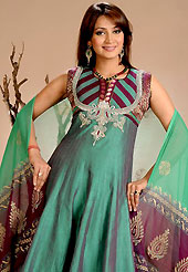 Be ready to slip in the comfort zone of this embroidered suit. The dazzling teal green dupion silk readymade churidar suit have amazing embroidery patch work is done with resham and zari work. The entire ensemble makes an excellent wear. Contrasting dark burgundy churidar and double dye dupatta is available with this suit. Slight Color variations are possible due to differing screen and photograph resolutions.