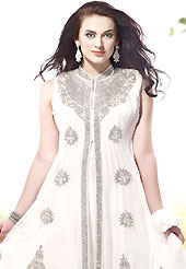 A desire that evokes a sense of belonging with a striking details. The dazzling white georgette readymade churidar suit have amazing embroidery patch work is done with stone work. The entire ensemble makes an excellent wear. Matching santoon churidar and chiffon dupatta is available with this suit. Slight Color variations are possible due to differing screen and photograph resolutions.