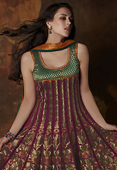 Embroidered suits are the best choice for a girl to enhance her feminine look. The dazzling burgundy and dark green banarasi brocade readymade churidar suit have amazing embroidery patch work is done with resham, zari and lace work. The entire ensemble makes an excellent wear. Matching dark green santoon churidar and dark green net dupatta is available with this suit. Slight Color variations are possible due to differing screen and photograph resolutions.