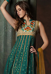 Take the fashion industry by storm in this beautiful embroidered suit. The dazzling teal green and light brown banarasi jacquard readymade churidar suit have amazing embroidery patch work is done with resham, zari, sequins, stone and lace work. The entire ensemble makes an excellent wear. Matching light brown santoon churidar and light brown net dupatta is available with this suit. Slight Color variations are possible due to differing screen and photograph resolutions.