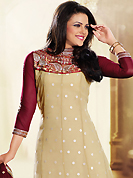 Dreamy variation on shape and forms compliment your style with tradition. The dazzling butter cream faux georgette churidar suit have amazing embroidery patch work is done with resham, zari, sequins and lace work. Beautiful embroidery work on kameez is stunning. The entire ensemble makes an excellent wear. Contrasting maroon santoon churidar and double dye net dupatta is available with this suit. Slight Color variations are possible due to differing screen and photograph resolutions.