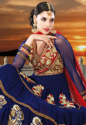Get ready to sizzle all around you by sparkling suit. The dazzling navy blue faux georgette anarkali churidar suit have amazing embroidery patch work is done with resham, zari, sequins, stone and lace work. Beautiful embroidery work on kameez is stunning. The entire ensemble makes an excellent wear. Matching santoon churidar and red net dupatta is available with this suit. Slight Color variations are possible due to differing screen and photograph resolutions.