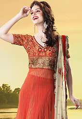 Dreamy variation on shape and forms compliment your style with tradition. The dazzling light rust net churidar suit have amazing embroidery patch work is done with resham, zari, sequins, stone, beads and lace work. Beautiful embroidery work on kameez is stunning. The entire ensemble makes an excellent wear. Contrasting red santoon churidar and cream net dupatta is available with this suit. Slight Color variations are possible due to differing screen and photograph resolutions.