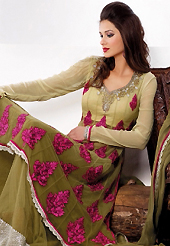 Ultimate collection of embroidered suits with fabulous style. The dazzling cream and shaded olive green net sharara kameez have amazing embroidery patch bordered work is done with resham, zari, stone, beads and lace work. Beautiful embroidery work on kameez is stunning. The entire ensemble makes an excellent wear. Matching olive green net sharara and olive green net dupatta is available with this suit. Slight Color variations are possible due to differing screen and photograph resolutions.