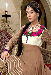 Dreamy variation on shape and forms compliment your style with tradition. The dazzling light brown georgette churidar suit have amazing embroidery patch work is done with resham, zari, stone and lace work. The entire ensemble makes an excellent wear. Contrasting purple churidar and purple dupatta is available with this suit. Slight Color variations are possible due to differing screen and photograph resolutions.