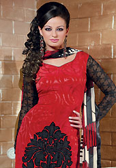 Get ready to sizzle all around you by sparkling suit. The dazzling red crepe churidar suit have amazing floral print and embroidery patch work is done with resham thread, stone, applique and lace work. The entire ensemble makes an excellent wear. Contrasting black churidar and printed dupatta is available with this suit. Slight Color variations are possible due to differing screen and photograph resolutions.