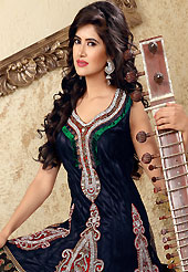 The glamorous silhouette to meet your most dire fashion needs. The dazzling dark navy blue and black net churidar suit have amazing embroidery patch bordered work is done with zari, cutdana, stones, bugle beads and lace work. Beautiful embroidery work on kameez is stunning. The entire ensemble makes an excellent wear. Matching churidar and dupatta is available with this suit. Slight Color variations are possible due to differing screen and photograph resolutions.