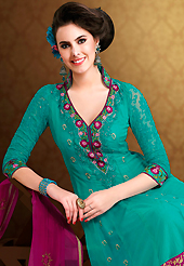 Get ready to sizzle all around you by sparkling suit. The dazzling turquoise green net georgette churidar suit have amazing embroidery patch work is done with resham, zari and sequins work. Beautiful embroidery work on kameez is stunning. The entire ensemble makes an excellent wear. Matching santoon churidar and magenta dupatta is available with this suit. Slight Color variations are possible due to differing screen and photograph resolutions.