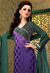 The glamorous silhouette to meet your most dire fashion needs. The dazzling shaded purple crepe jacquard churidar suit have amazing embroidery patch work is done with zari and stone work. The entire ensemble makes an excellent wear. Contrasting dark green santoon churidar and dark green chiffon dupatta is available with this suit. Slight Color variations are possible due to differing screen and photograph resolutions.