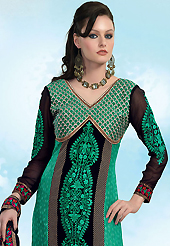 The glamorous silhouette to meet your most dire fashion needs. The dazzling turquoise green and black georgette churidar suit have amazing embroidery patch work is done with resham, zari and lace work. The entire ensemble makes an excellent wear. Matching turquoise green santoon churidar and black chiffon dupatta is available with this suit. Slight Color variations are possible due to differing screen and photograph resolutions.