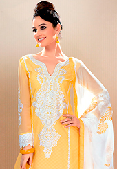 A desire that evokes a sense of belonging with a striking details. This yellow cotton jacquard churidar suit have amazing embroidery patch work is done with resham, stone and lace work. Embroidery on kameez is highlighting the beauty of this suit. Contrasting off white churidar and off white chiffon dupatta come along with this suit. Slight Color variations are possible due to differing screen and photograph resolutions.