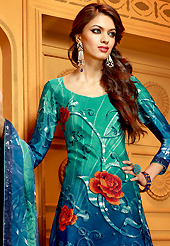 It is color this season and bright shaded suits are really something that is totally in vogue. The dazzling shaded green and dark blue faux crepe churidar suit have amazing floral print, sequins and stone work. The entire ensemble makes an excellent wear. Matching santoon churidar and dupatta is available with this suit. Slight Color variations are possible due to differing screen and photograph resolutions.