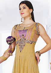 Outfit is a novel ways of getting yourself noticed. The dazzling fawn and purple net readymade churidar suit have amazing embroidery and brocade patch bordered work is done with resham, sequins, stone, kasab and lace work. Beautiful embroidery work on kameez is stunning. The entire ensemble makes an excellent wear. Matching purple santoon churidar and double dye net dupatta is available with this suit. Slight Color variations are possible due to differing screen and photograph resolutions.