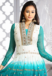 Take the fashion industry by storm in this beautiful embroidered suit. The dazzling shaded off white and turquoise net readymade anarkali churidar suit have amazing embroidery patch work is done with zari, stone and lace work. Beautiful embroidery work on kameez is stunning. The entire ensemble makes an excellent wear. Matching turquoise santoon churidar and turquoise faux chiffon dupatta is available with this suit. Slight Color variations are possible due to differing screen and photograph resolutions.