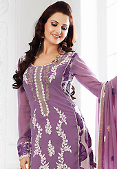 Outfit is a novel ways of getting yourself noticed. The dazzling lavender and off white faux georgette churidar suit have amazing embroidery patch work is done with resham, zari and lace work. Beautiful embroidery work on kameez is stunning. The entire ensemble makes an excellent wear. Matching santoon churidar and faux chiffon dupatta is available with this suit. Slight Color variations are possible due to differing screen and photograph resolutions.