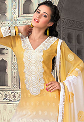 Look stunning rich with dark shades and floral patterns. The dazzling shaded yellow and white georgette churidar suit have amazing embroidery patch work is done with resham and lace work. The entire ensemble makes an excellent wear. Matching yellow santoon churidar and shaded chiffon dupatta is available with this suit. Slight Color variations are possible due to differing screen and photograph resolutions.