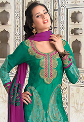 Dreamy variation on shape and forms compliment your style with tradition. The dazzling green jacquard churidar suit have amazing embroidery patch work is done with resham work. The entire ensemble makes an excellent wear. Matching santoon churidar and magenta chiffon dupatta is available with this suit. Slight Color variations are possible due to differing screen and photograph resolutions.