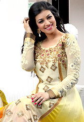 Your search for elegant look ends here with this lovely suit. The dazzling shaded cream, yellow and orange georgette anarkali churidar suit have amazing embroidery patch work is done with resham, zari, sequins, stone and lace work. Beautiful embroidery work on kameez is stunning. The entire ensemble makes an excellent wear. Matching cream santoon churidar and yellow chiffon dupatta is available with this suit. Slight Color variations are possible due to differing screen and photograph resolutions.