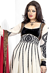 Get ready to sizzle all around you by sparkling suit. The dazzling cream and black georgette anarkali churidar suit have amazing embroidery patch work is done with resham and stone work. Beautiful embroidery work on kameez is stunning. The entire ensemble makes an excellent wear. Matching black santoon churidar and red chiffon dupatta is available with this suit. Slight Color variations are possible due to differing screen and photograph resolutions.