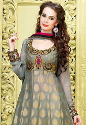 Attract all attentions with this embroidered suit. The dazzling light grey viscose georgette long pakistani style churidar suit have amazing embroidery patch work is done with resham, zari, sequins, stone and lace work. Beautiful embroidery work on kameez is stunning. The entire ensemble makes an excellent wear. Matching santoon churidar and faux chiffon dupatta is available with this suit. Slight Color variations are possible due to differing screen and photograph resolutions.
