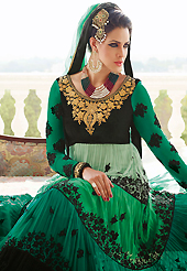 The glamorous silhouette to meet your most dire fashion needs. The dazzling shaded green and black georgette and velvet anarkali churidar suit have amazing embroidery patch work is done with resham, zari, stone and beads work. Beautiful embroidery work on kameez is stunning. The entire ensemble makes an excellent wear. Matching green santoon churidar and green chiffon dupatta is available with this suit. Slight Color variations are possible due to differing screen and photograph resolutions.