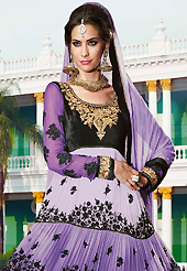 Dreamy variation on shape and forms compliment your style with tradition. The dazzling shaded purple and black georgette and velvet anarkali churidar suit have amazing embroidery patch work is done with resham, zari, stone and beads work. Beautiful embroidery work on kameez is stunning. The entire ensemble makes an excellent wear. Matching green santoon churidar and green chiffon dupatta is available with this suit. Slight Color variations are possible due to differing screen and photograph resolutions.