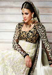 Attract all attentions with this embroidered suit. The dazzling off white and black net anarkali churidar suit have amazing embroidery patch work is done with resham, zari, stone and beads work. Beautiful embroidery work on kameez is stunning. The entire ensemble makes an excellent wear. Matching off white santoon churidar and off white chiffon dupatta is available with this suit. Slight Color variations are possible due to differing screen and photograph resolutions.