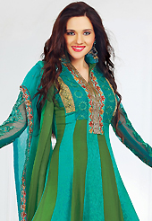 A desire that evokes a sense of belonging with a striking details. The dazzling turquoise green and olive green faux crepe jacquard and faux chiffon churidar suit have amazing embroidery patch work is done with resham, zari and lace work. The entire ensemble makes an excellent wear. Matching turquoise santoon churidar and double dye chiffon dupatta is available with this suit. Slight Color variations are possible due to differing screen and photograph resolutions.