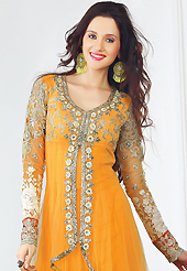 Attract all attentions with this embroidered suit. The dazzling bright yellow net churidar suit have amazing embroidery patch work is done with resham, zari, sequins, stone, beads and lace work. The entire ensemble makes an excellent wear. Matching santoon churidar and chiffon dupatta is available with this suit. Slight Color variations are possible due to differing screen and photograph resolutions.