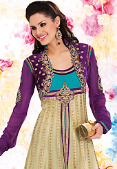Look stunning rich with dark shades and floral patterns. The dazzling beige and purple net and georgette churidar suit have amazing embroidery patch work is done with resham, zari, sequins, stone and lace work. Beautiful embroidery work on kameez is stunning. The entire ensemble makes an excellent wear. Matching purple santoon churidar and turquoise chiffon dupatta is available with this suit. Slight Color variations are possible due to differing screen and photograph resolutions.