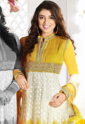 The glamorous silhouette to meet your most dire fashion needs. The dazzling off white and yellow net churidar suit have amazing embroidery patch work is done with resham, zari, sequins, stone, cutdana and beads work. Beautiful embroidery work on kameez is stunning. The entire ensemble makes an excellent wear. Matching yellow churidar and off white net dupatta is available with this suit. Slight Color variations are possible due to differing screen and photograph resolutions.