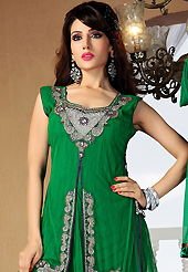 The glamorous silhouette to meet your most dire fashion needs. The dazzling green net readymade churidar suit have amazing embroidery and velvet patch work is done with zari, cutdana and stone work. The entire ensemble makes an excellent wear. Contrasting purple santoon churidar and green net dupatta is available with this suit. Slight Color variations are possible due to differing screen and photograph resolutions.